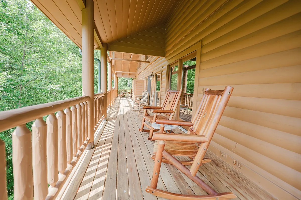 This image shows a tranquil porch with wooden rocking chairs overlooking lush greenery. It's a serene spot ideal for morning coffee, evening chats, or simply unwinding after a day of group adventures.